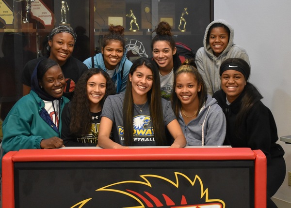 Women's basketball player Madeline Gray (center) pictured with some of her teammates signed a scholarship this week to continue her basketball career at Midway University.